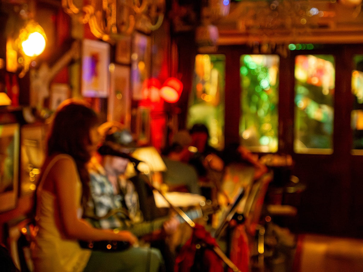 A live band playing in a warmly lit Atlanta bar, out of focus